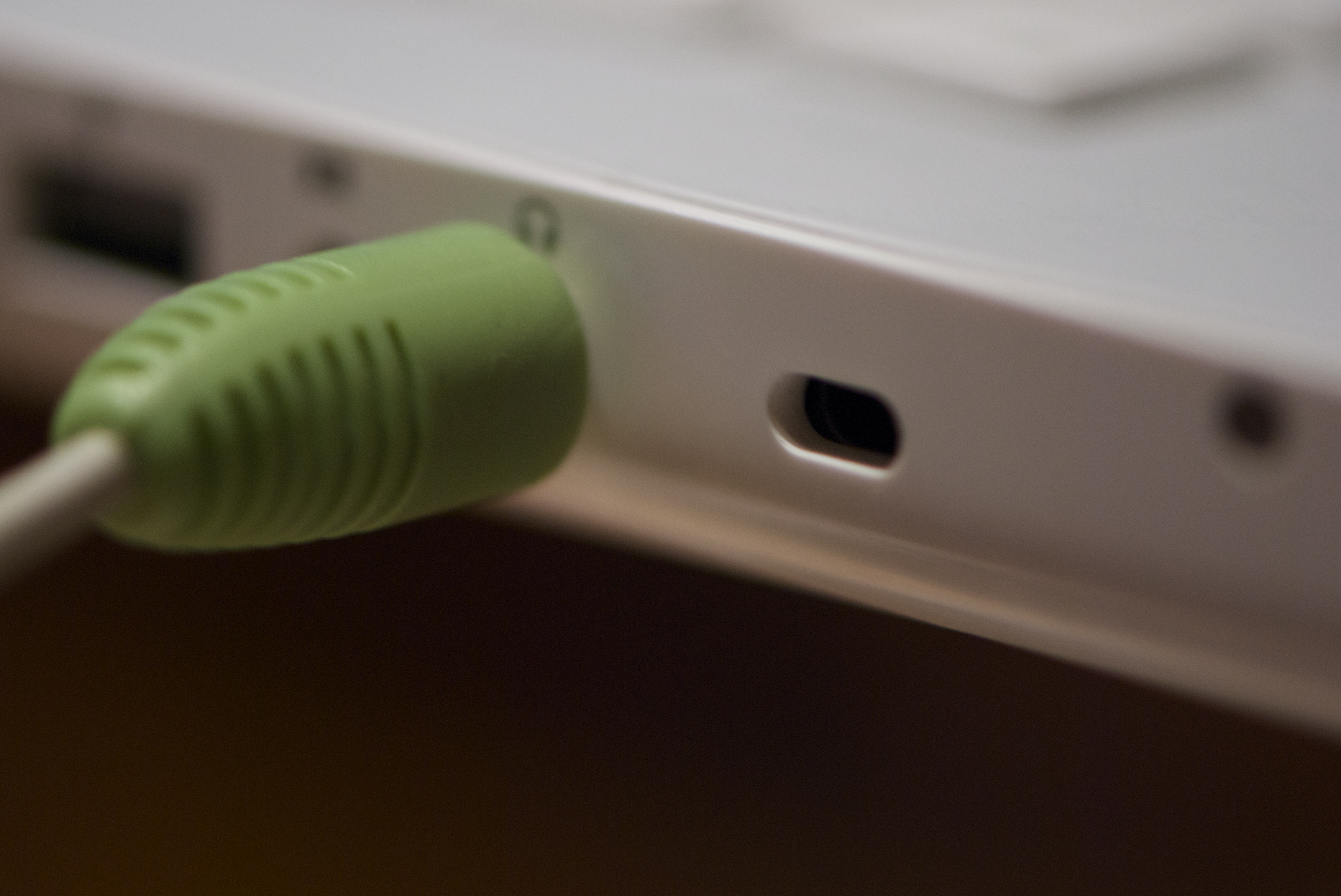 A padlock attached to a laptop security lock, representing website security and access control.